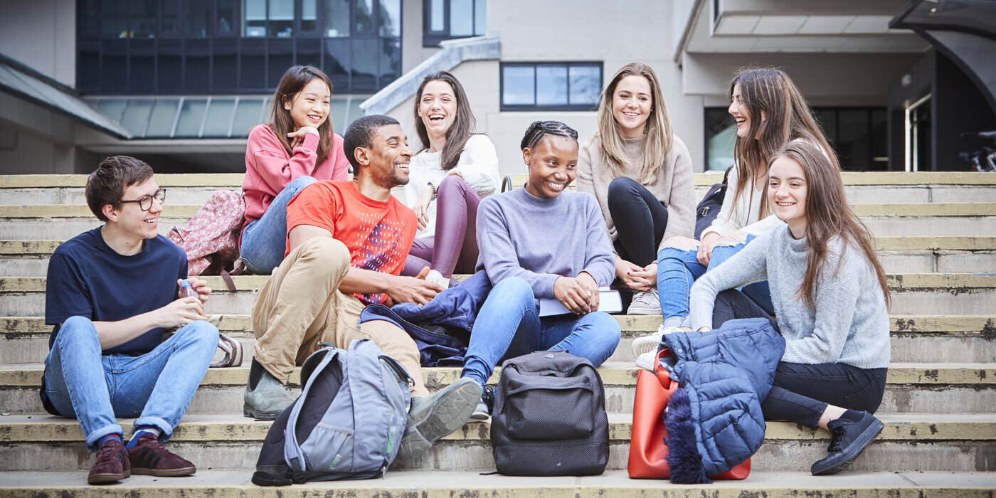 Students relaxing on the steps by the Social Sciences Building