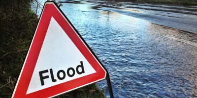 Flood sign on a flooded road