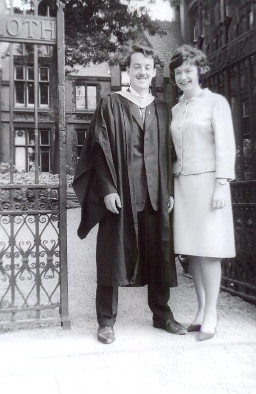 Black and white photo of Peter and his wife in front of the Great Hall