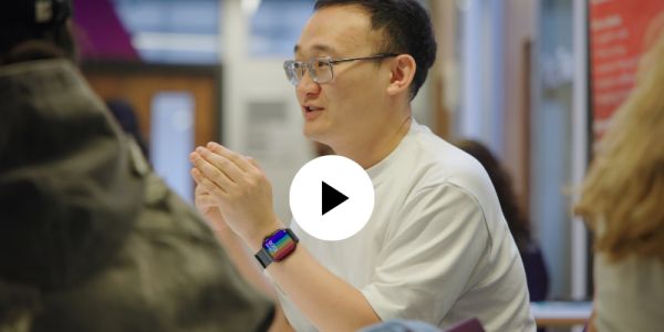 Staff member talking to students