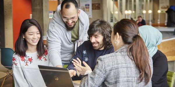 Group of masters students talking