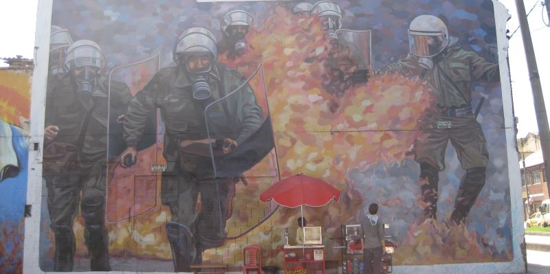 Photo of mural showing riot police running through fire.