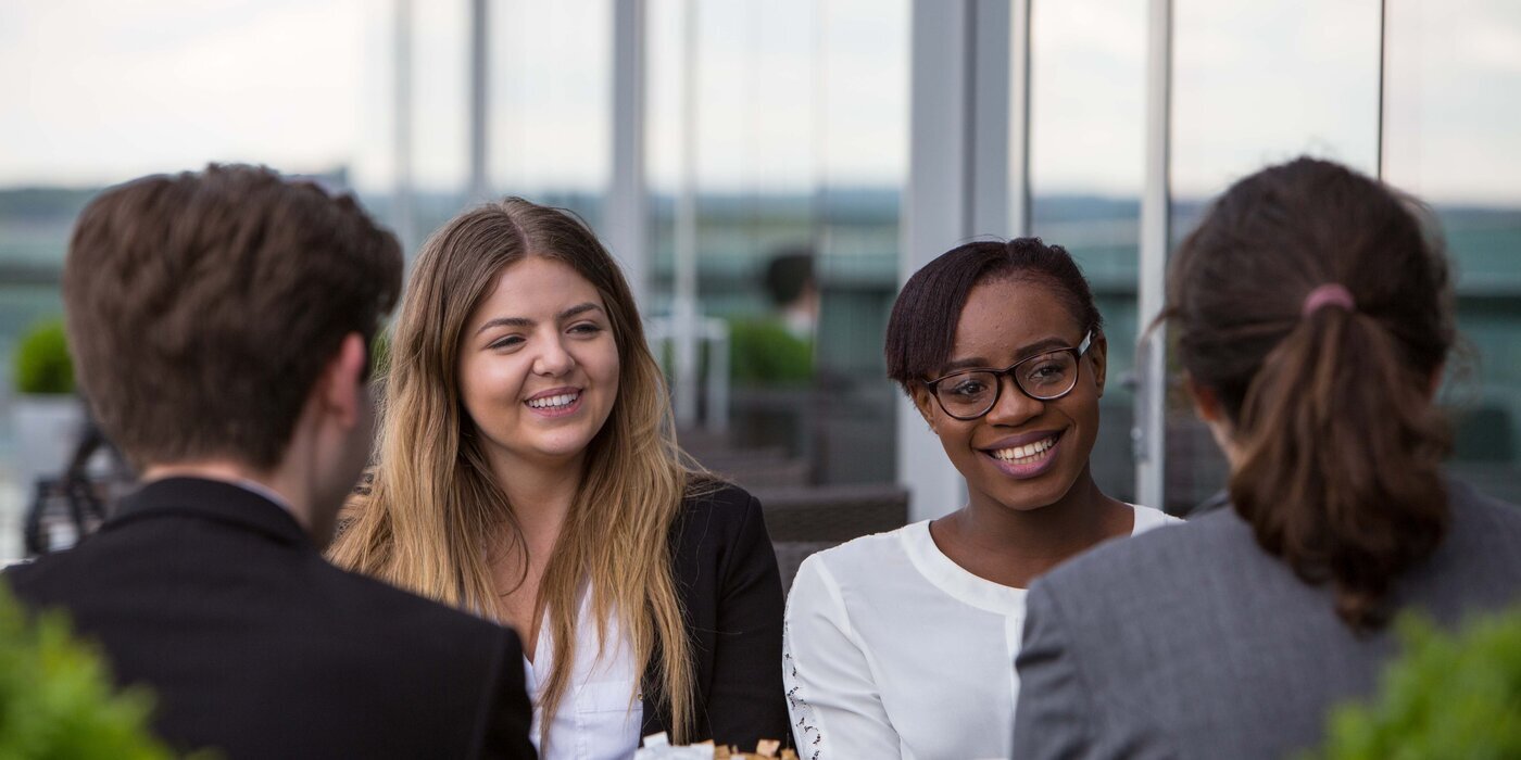 Four students discussing career success