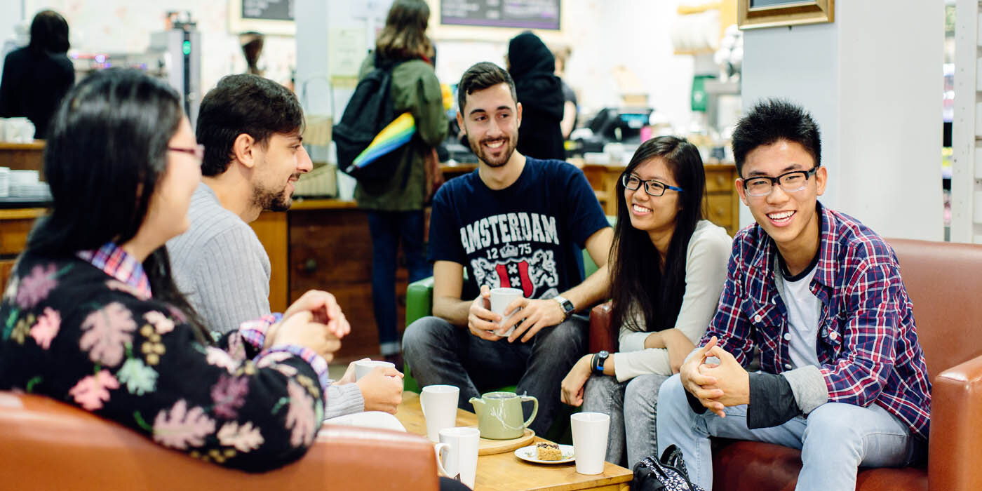 A group of students chatting in a cafe