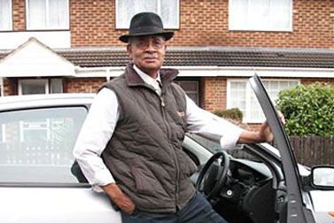 Man standing in front of white car