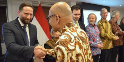 Adam Tyson receiving his award from the Indonesian Ambassador