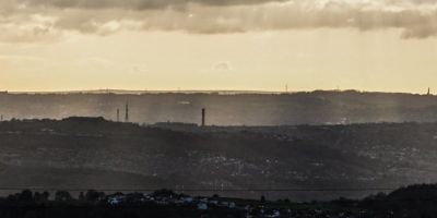 Sepia tinted clouds over a town.