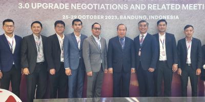 A group of men in suits stand in front of a wall that reads: ' the 4th round of ASEAN-China FTA 3.0 Upgrade Negotiations and Related Meeting' 25-29 October, 2023. Bandung, Indonesia