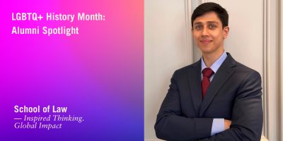 LGBTQ+ History Month: Alumni Spotlight graphic. On the left, a pink-to-blue gradient background with white text. On the right, a young person in a navy suit, red tie, and light blue shirt stands with arms crossed, smiling confidently.