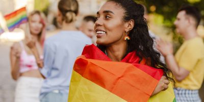 Woman at Pride march wearing a flag