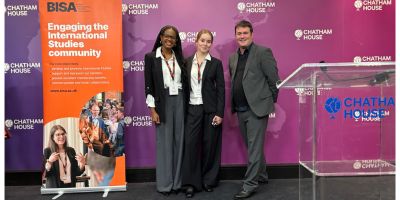 Photograph of students Sanaa and Ines, with Prof. Simon Lightfoot at the climate negotiation simulation.