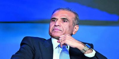 A photo of Sunil Mittal, the Founder and Chairman of Bharti Enterprises, wearing a suit and tie, sitting with a thoughtful expression against a blue background