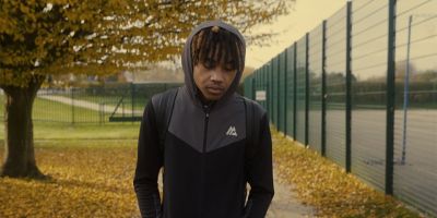 A young man walks on a path