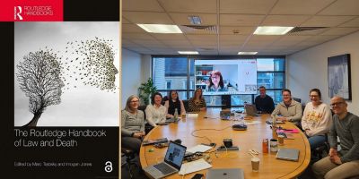 To the left, an image of the Handbook's cover, and to the right a picture of Dr Jones and others at the launch.