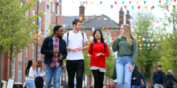 Students chatting and walking around campus