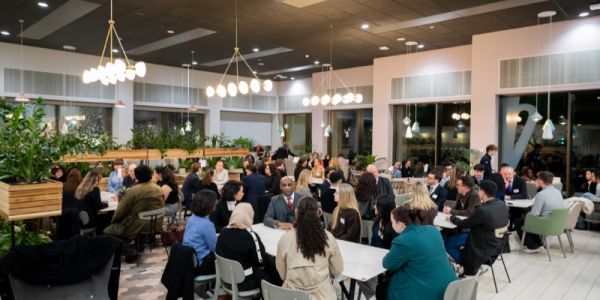 Attendee sit around tables chatting