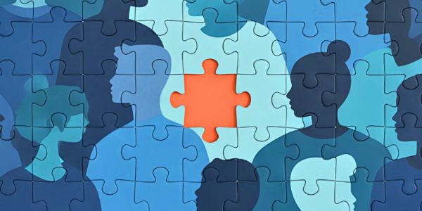 A blue jigsaw puzzle of children's silhouettes, with a piece missing showing an orange background.