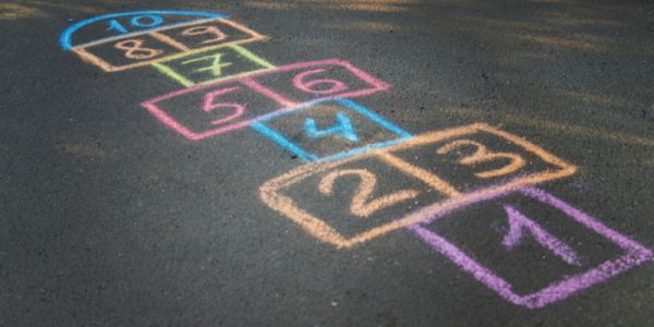 Playground with hopscotch drawn on it in chalk