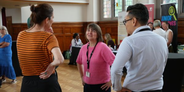 Educator's Breakfast 2026 attendees talking amongst themselves