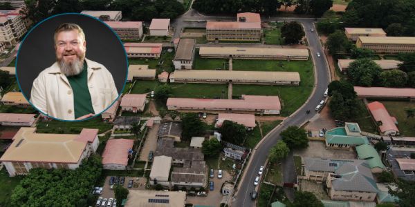 An aerial view of Ibadan University. Dr Nick Cartwright smiling in a circular frame over the top.