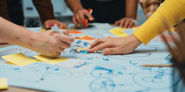 Children's hands writing on a piece of paper