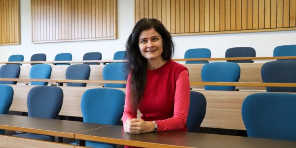 A smiling photo of Dr Blazsek in a lecture theatre
