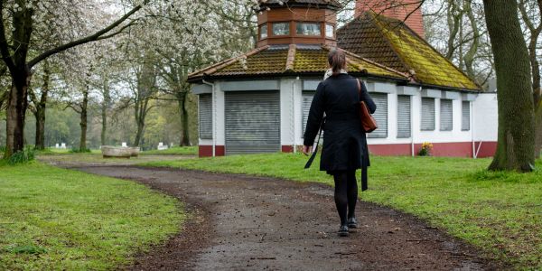 A woman walking through Woodhouse Moor.
