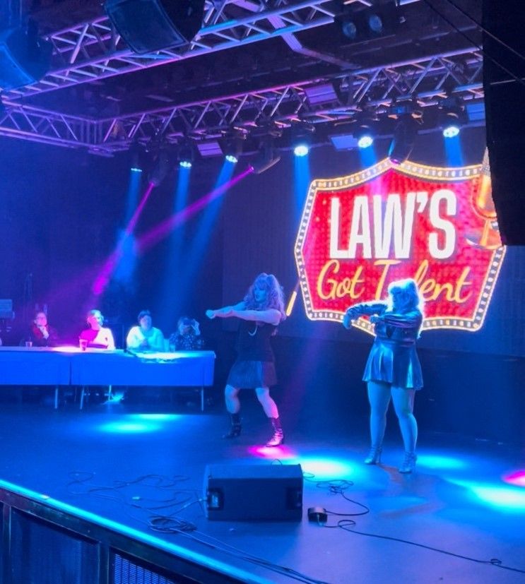 Rosie and James in drag performing on stage