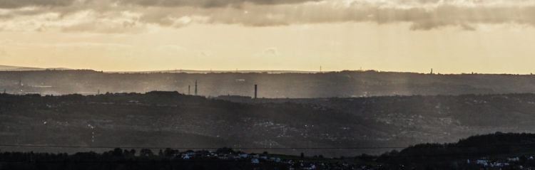 Sepia tinted clouds over a town.