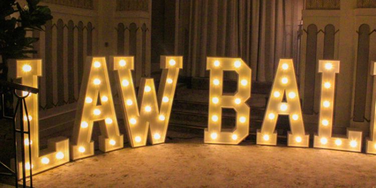 Illuminated marquee letters spelling LAW BALL at an elegant event venue, showcasing a sophisticated and celebratory atmosphere.
