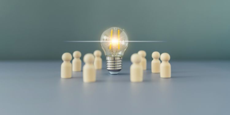 Image of lightbulb surrounded by little wooden people