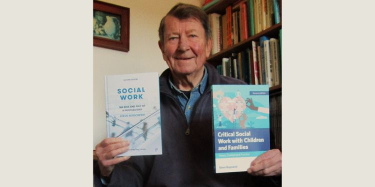 Dr Steve Rogowski holding up copies of his two books