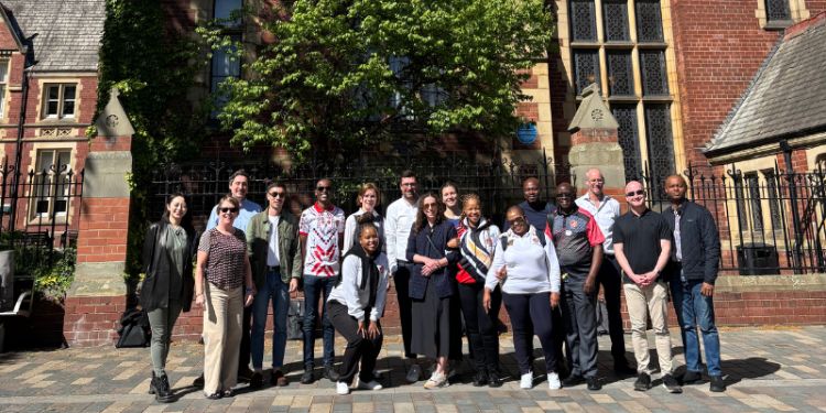  a delegation from the NUM and SATRI stands in front of the Great Hall at the University of Leeds