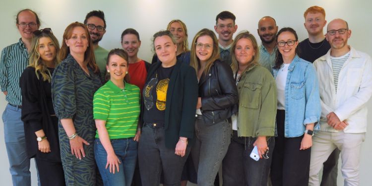 CCJS members smiling against a blank wall on their away day 2026
