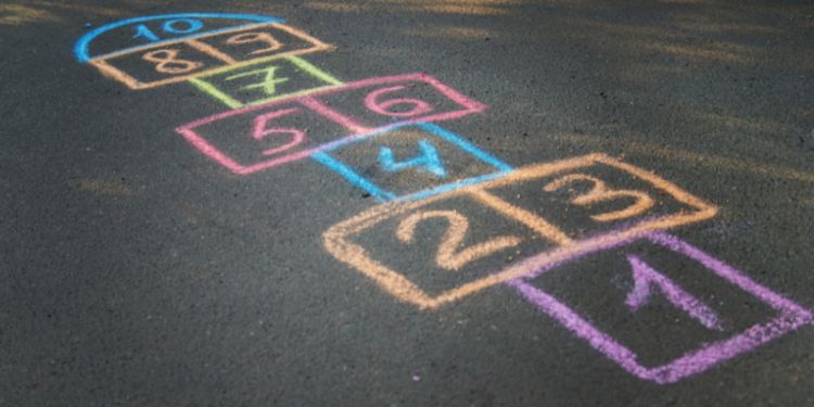 Playground with hopscotch drawn on it in chalk
