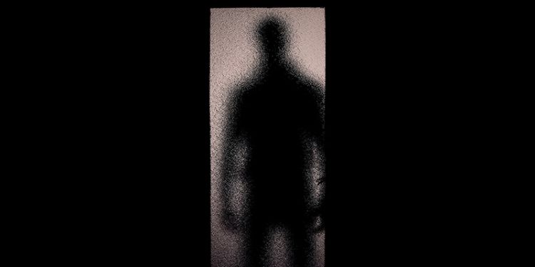 Shadowy figure in doorway