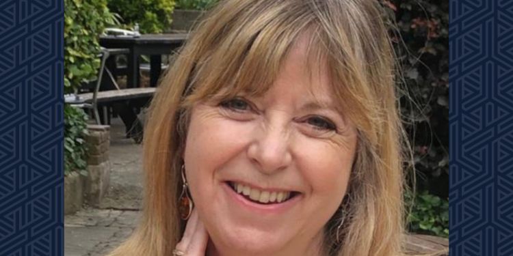 Smiling photo of Prof Joanne Conaghan against a navy blue background