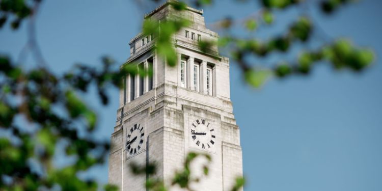 Photo of Parkinson Building through the trees, with leaves in front of it.