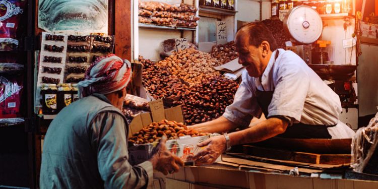 Man selling dates at a market
