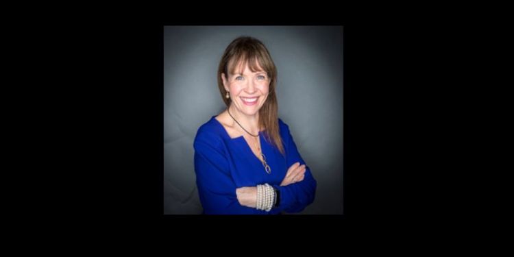 Headshot of Karen McCloskey against a black background.