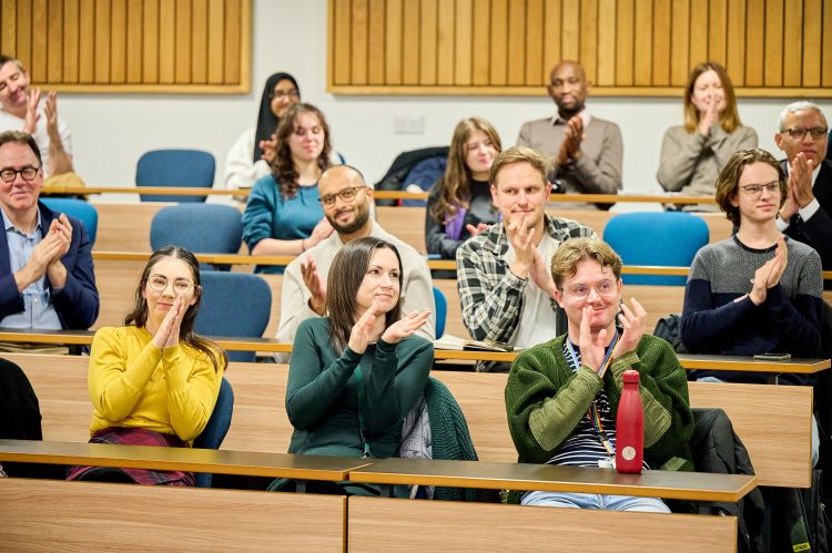Audience applause at Professor Nicholson's lecture.
