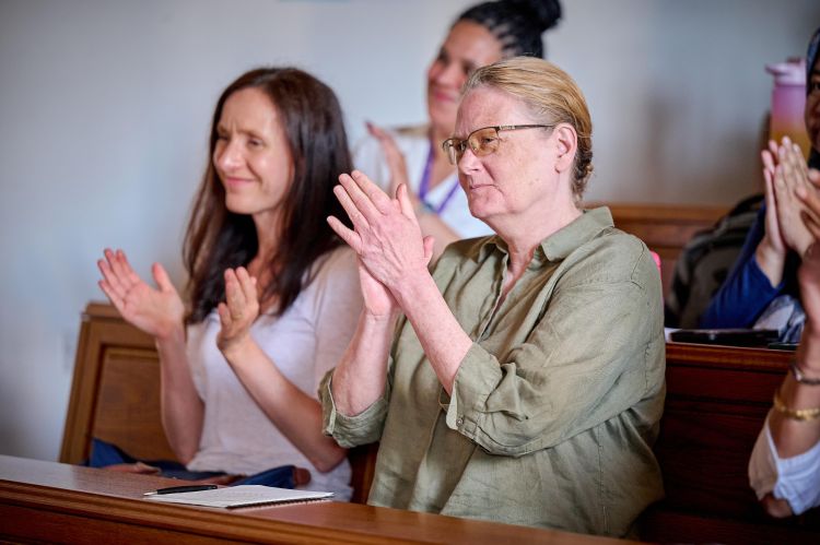 Photograph of audience applause at Professor Tracey's lecture.