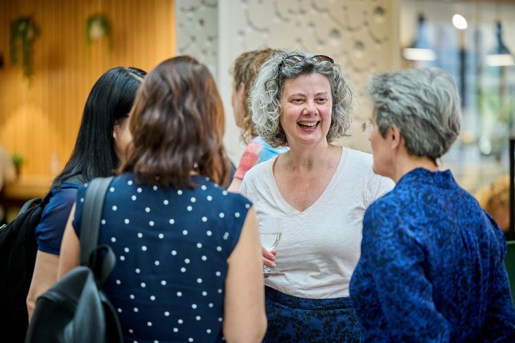 Photograph of colleagues talking at the drinks reception following the lecture.