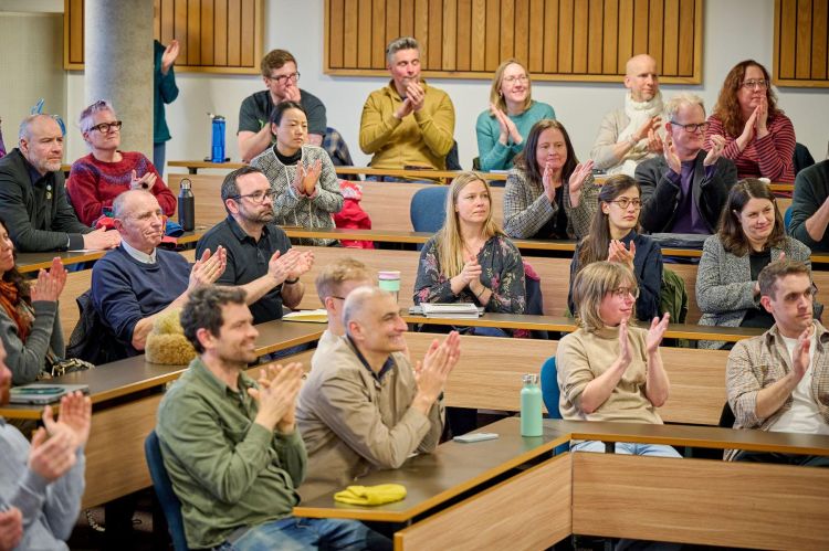 Audience applause at Professor Davis' lecture.