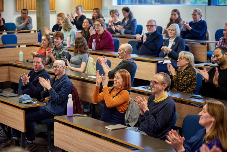 Audience applause at Professor Yeomans' lecture.