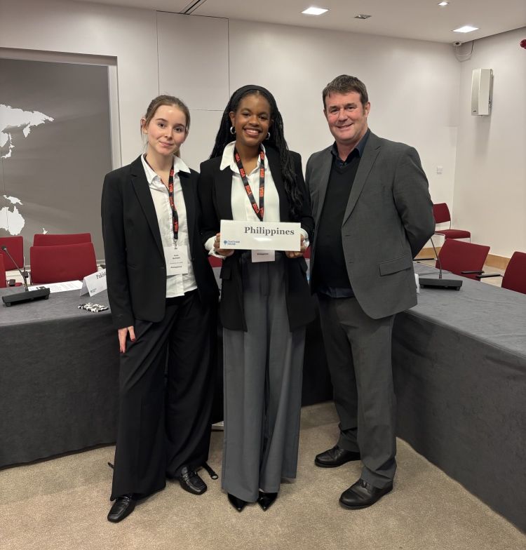 From left to right photographed are: Ines Achtell, Sanaa Elcock (holding a sign reading 'Philippines'), and Prof. Simon Lightfoot.