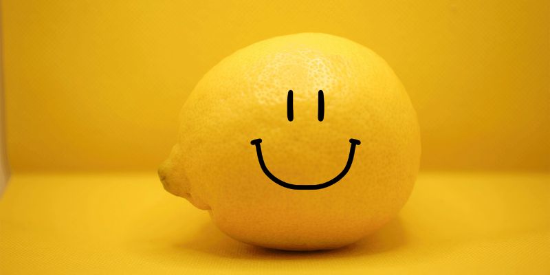 Photo of a lemon with a smile drawn on it