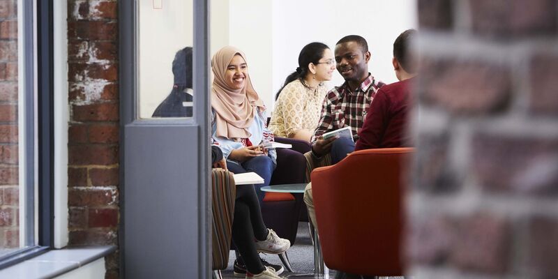 Doctoral students discussing research.