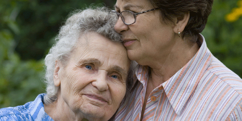 older woman and her daughter embracing