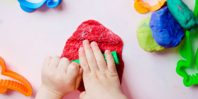 Child playing with play dough